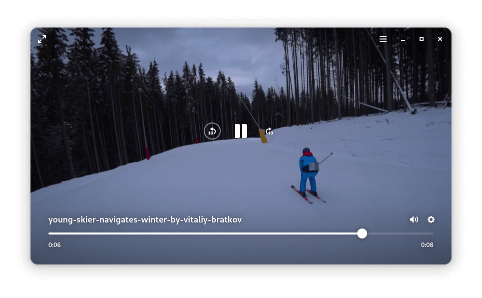 gnome showtime playing a video of a skier going down a winter forest slope