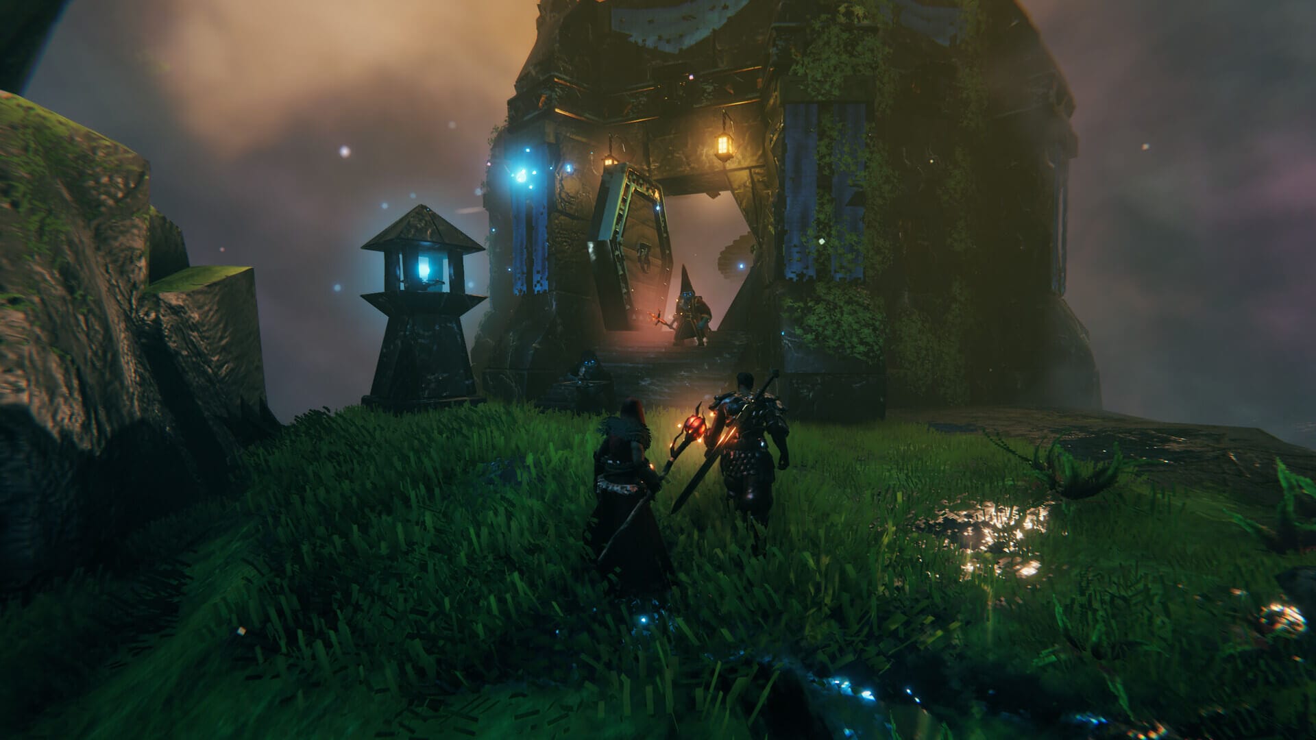 two players are approaching someone stood at a doorway to a structure, all of them have weapons in their hands or back