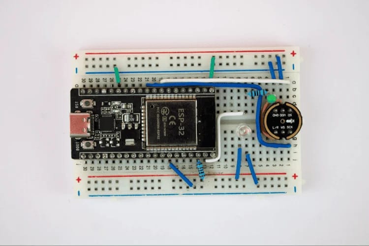 this picture is showcasing the esp32 microcontroller project for voice recognition using edge impulse against a white background, you can see the breadbord and the attached doodads on there