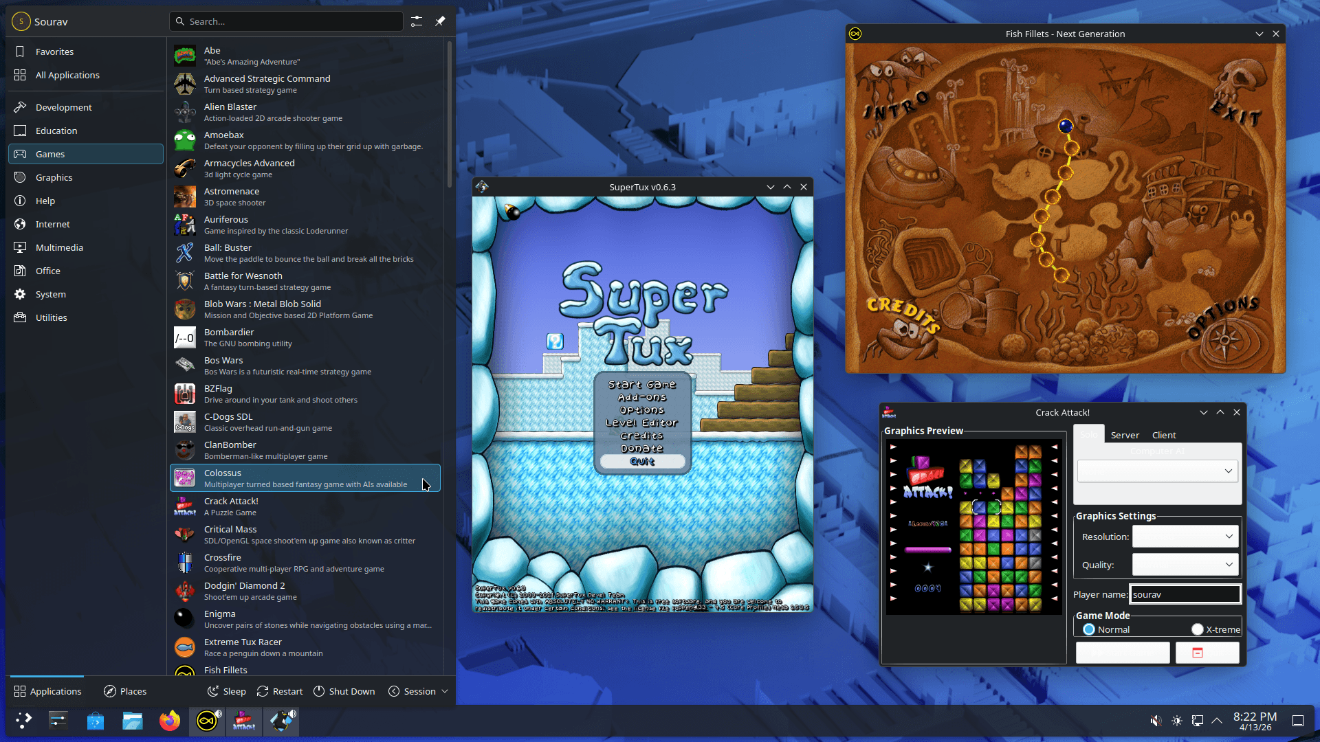 a screenshot of fedora 44 games lab with the application launcher open showing many games in a list on the left, and on the right are three games that are running: super tux, crack attack!, and fish fillets - next generation