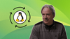 there is a circular illustration on the left that shows a cycle with tux, the penguin mascot of linux in it, on the right is a picture of linus torvalds wearing a spider-man-themed sweatshirt