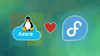 tux, the mascot penguin of linux is sat on top of a blue-colored azure cloud, in the middle is a heart symbol, on the right is the fedora logo