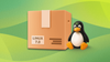against a mixed green wallpaper, there is a big brown cardboard box with linux 7.0 written on it, on its right sits a chonky tux, the mascot pengiun of linux