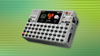 against a striped green background is a white-colored cardputerzero device